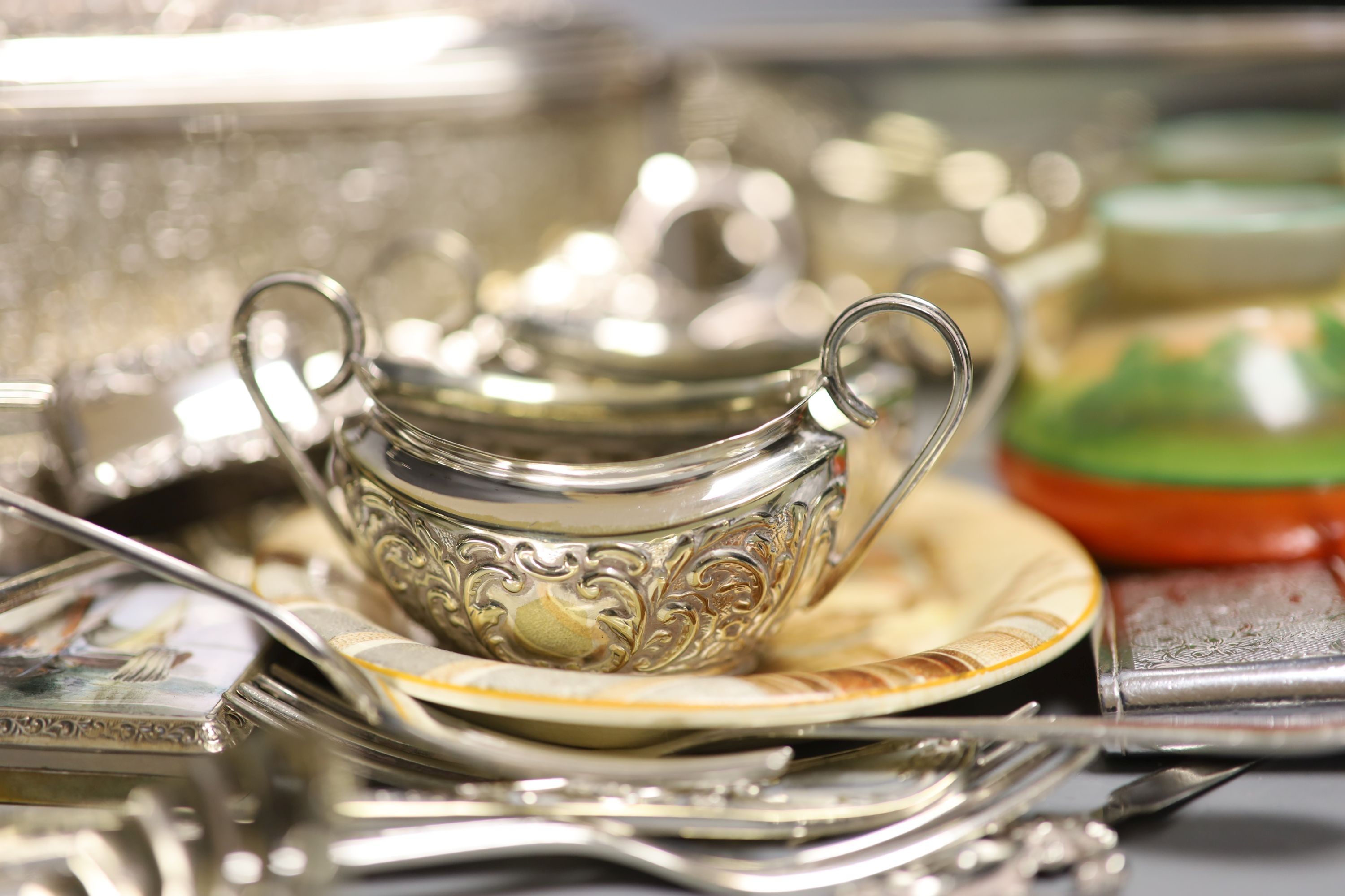 A collection of silver plate to include an enamelled box, candle snuffers, cutlery, box etc